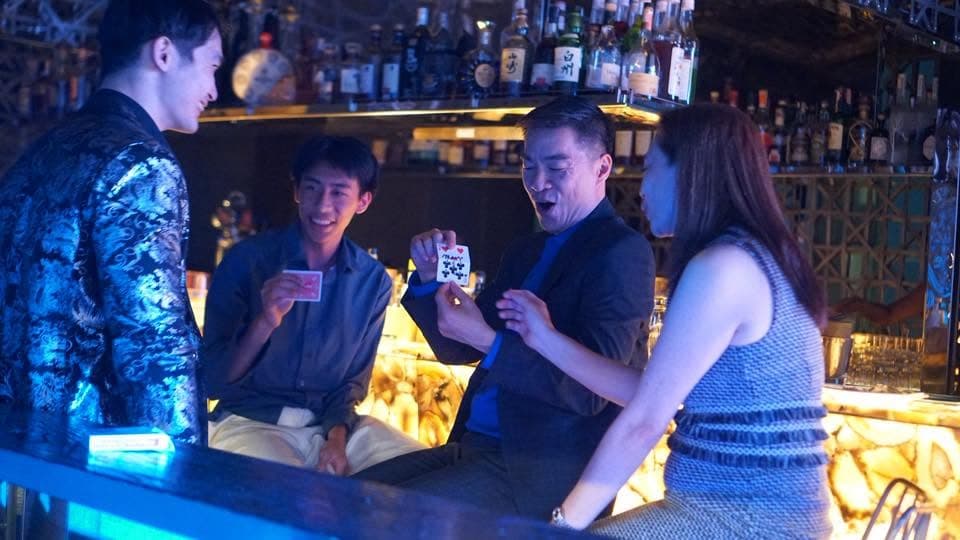 Close-up card magic at a bar